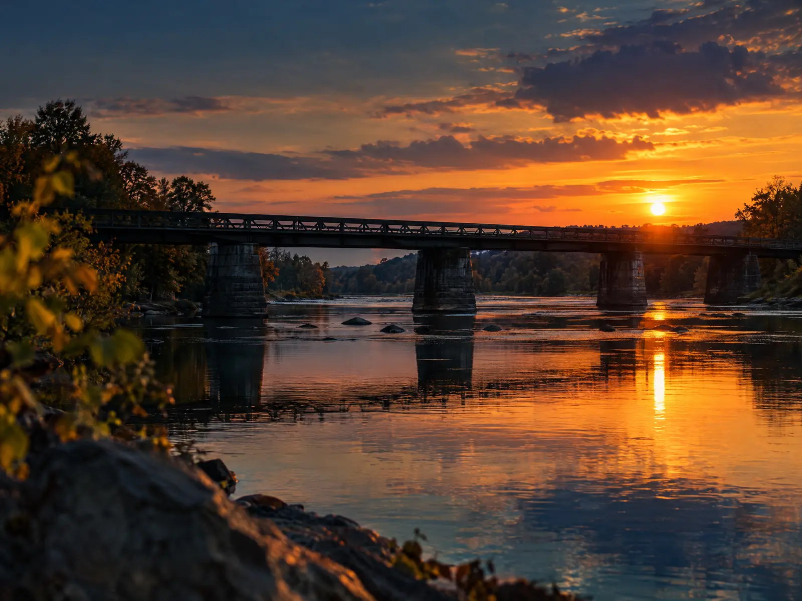 Bridge over the Appomattox River at sunset with calm water reflecting the sky